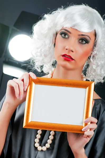 Young attractive girl with blank picture frame — Stock Photo, Image