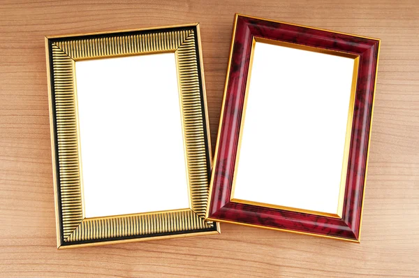 Picture frames on the polished wooden background — Stock Photo, Image