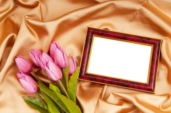 Picture frames and tulips flowers on satin — Stock Photo, Image