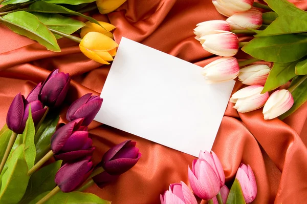 Saten arkaplanda zarf ve çiçekler — Stok fotoğraf
