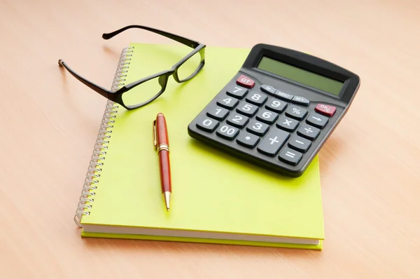 Business concept with notepad and calculator — Stock Photo, Image