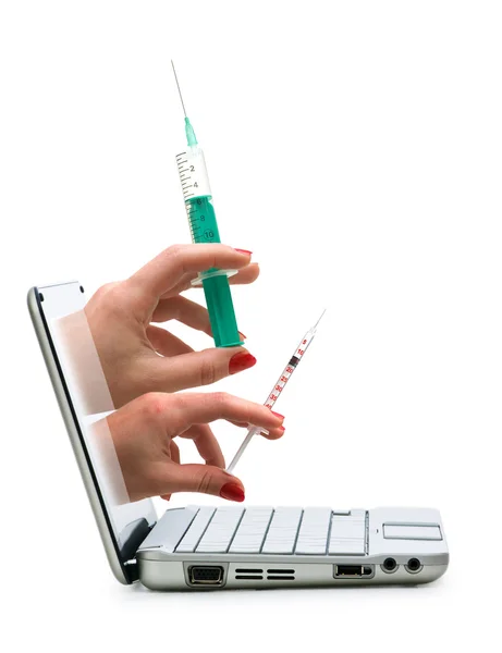 Hands with syringes out of netbook screen — Stock Photo, Image