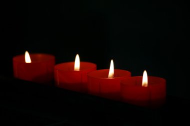 A few conflagrant candles are in darkness clipart