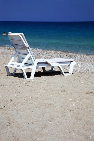 stock image Sunbed near water on a sandy beach