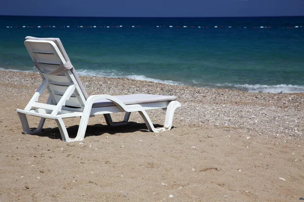 Stock image Sunbed near water on a sandy beach