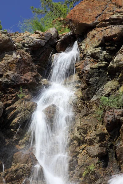 stock image Waterfall, water stream falling from a rock