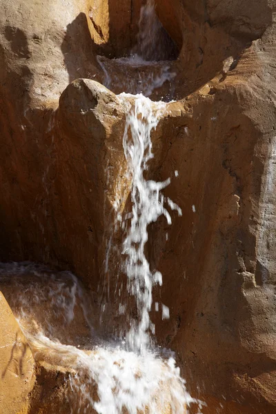 stock image Water flowing on a rock