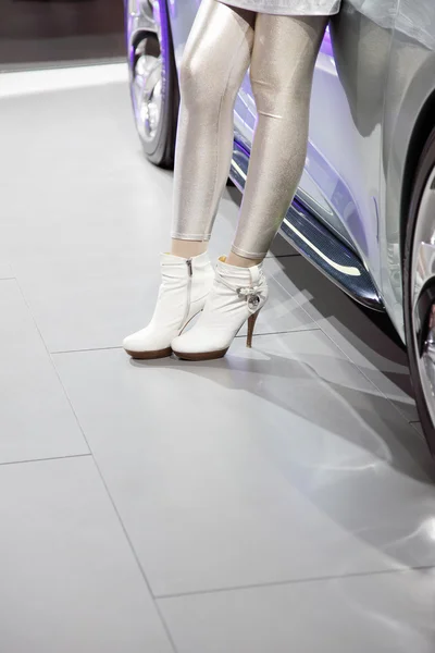 Girl near the car at an exhibition — Stock Photo, Image