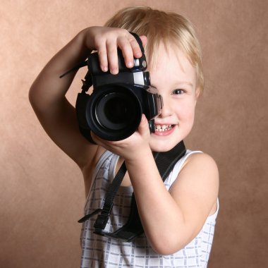 Child in studio with professional camera clipart