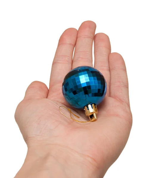 Hand holding a blue Christmas ornament on a white background — Stock Photo, Image