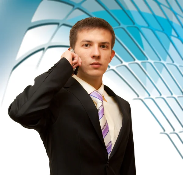 Handsome business man with a phone in their hands on an abstract — Stock Photo, Image