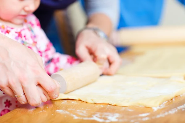 Closeup of family baking pie — Stock Photo, Image