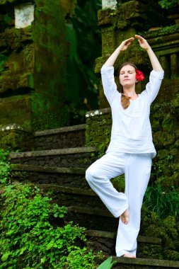 Beautiful woman practicing yoga clipart