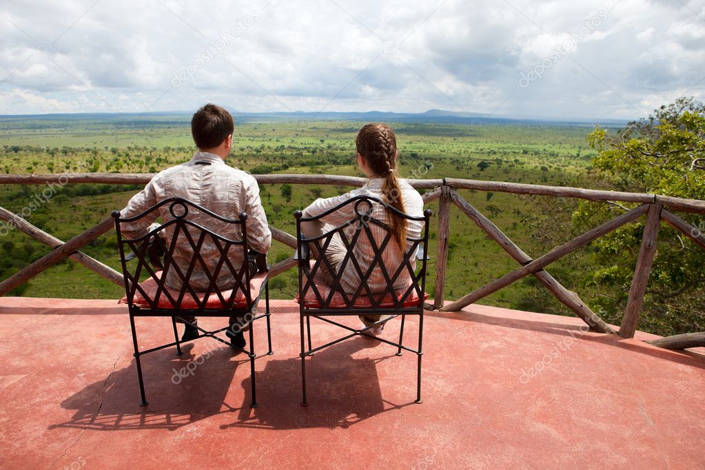 Couple on balcony of safari lodge