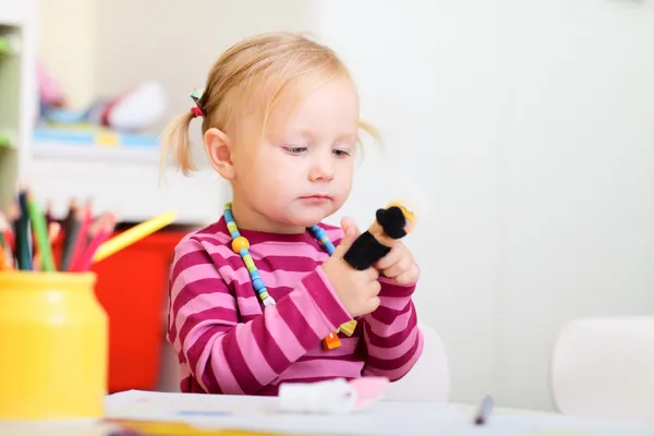 Toddler girl playing with finger puppets — Stock Photo, Image