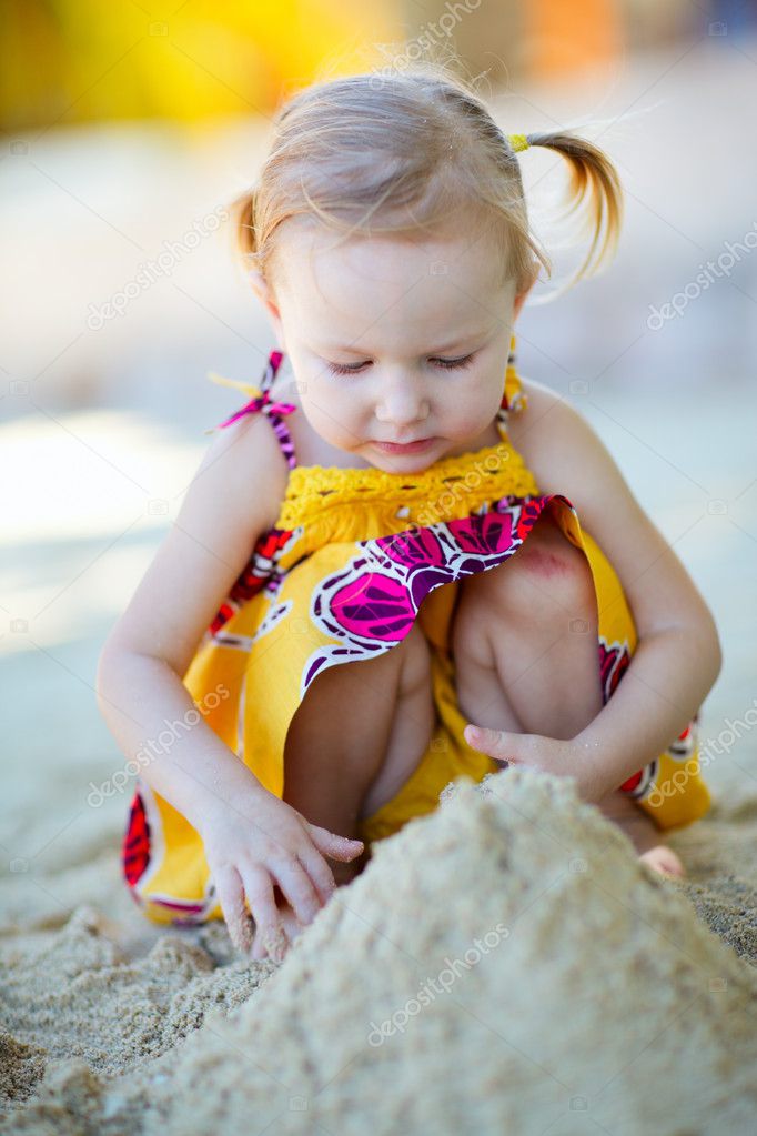 Little girl playing at beach Stock Photo by ©shalamov 4661855