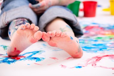 Macro photo of 5 years old boy painting on white background clipart