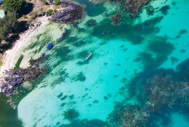 Aerial view of small boats in turquoise waters of Indian ocean clipart