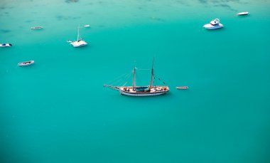 Aerial view of small boats in turquoise waters of Indian ocean clipart