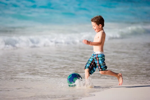 热带海滩上玩球的快乐小男孩 — 图库照片