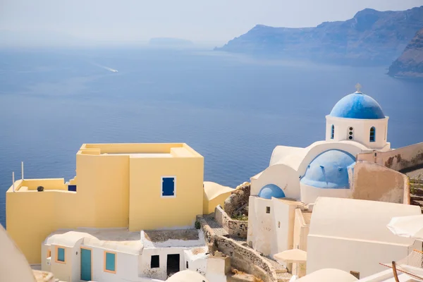 オイアで青いドーム教会 ギリシャのサントリーニ島の美しい島を取り巻く壮大なカルデラを一望します — ストック写真