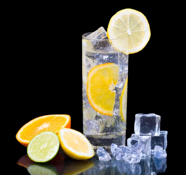 stock image Citrus Ice Water. Citrus ice water glass and citrus fruits over black background