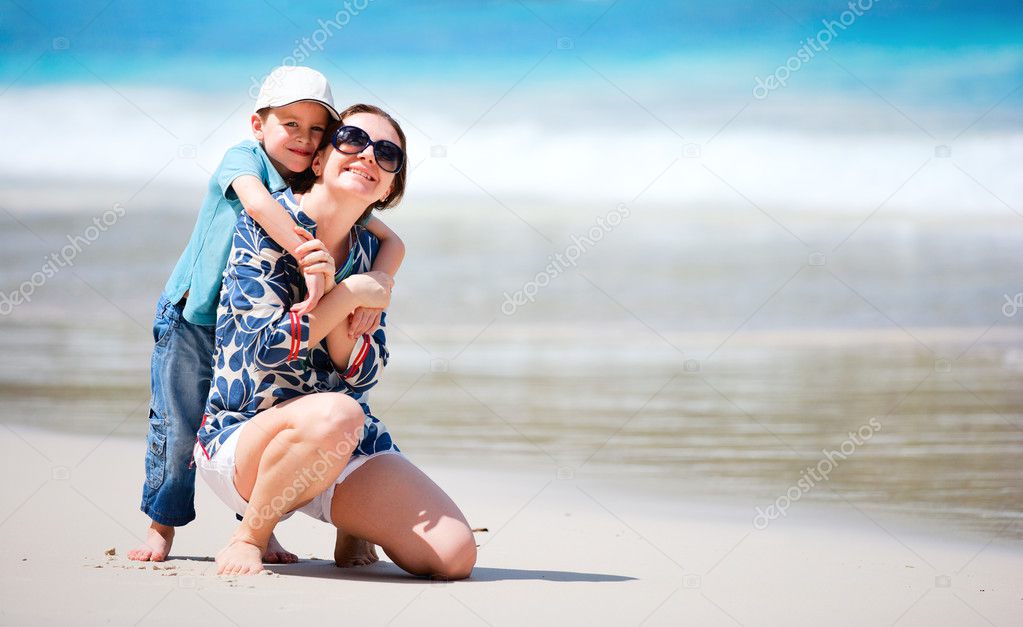 Mother and son having fun beach vacation