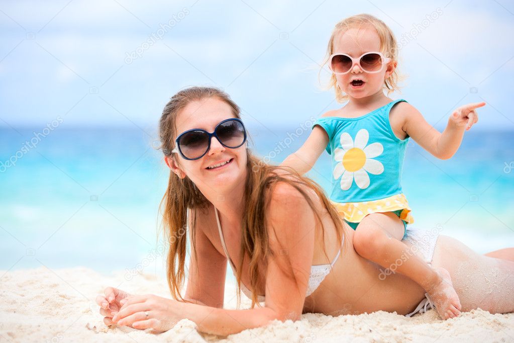 Young mother and her adorable little daughter on beach vacation