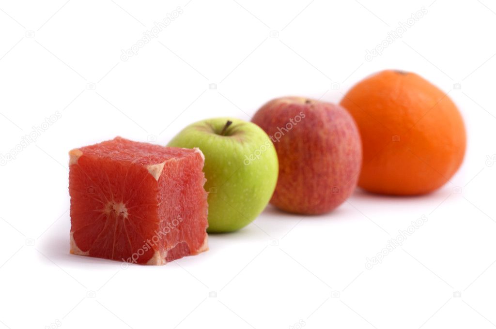 Be different... Cube shaped fresh grapefruit and other round shaped fruits (green apple, red apple, orange). Conceptual image isolated on white background.
