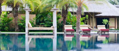 Panorama of beautiful wellness area and swimming pool in luxury resort. clipart