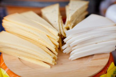 Different kinds of cheese served for tasting at Alkmaar cheese market, The Netherlands clipart