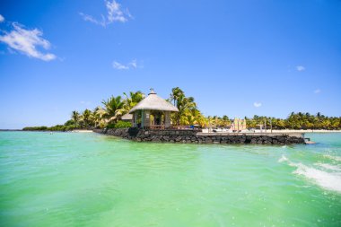 Beautiful ocean and tropical resort with boathouse. clipart