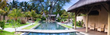 Panorama of beautiful wellness area and swimming pool in luxury resort. clipart