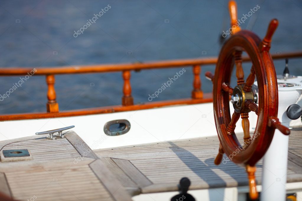 Wooden wheel on luxury yacht
