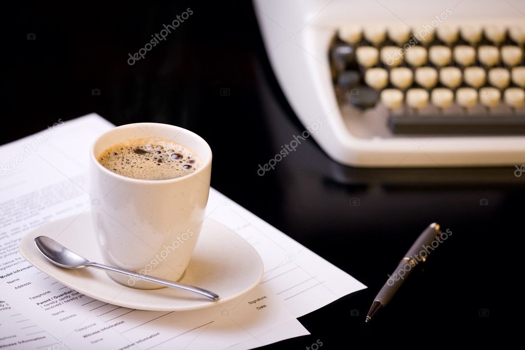 Good morning. Old fashioned morning scene: antique typewriter, cup of fresh coffee, business contract and pen