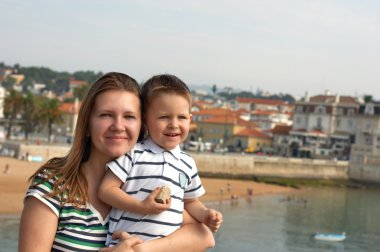 mutlu anne ve oğlu Avrupa varış noktasında. tipik Avrupa bir kasaba turuncu çatı arka planda görünür