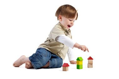 Choosing the right house. Cute little boy pointing to one of three wooden houses. clipart