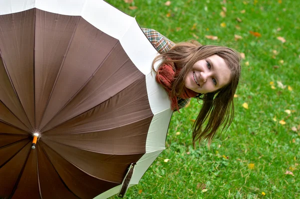 stock image Beautiful young woman with umbrella in the park at sunny fall day