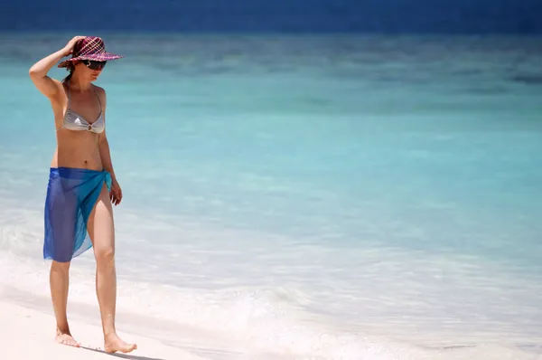 白い砂浜のビーチを歩いてサロンで若い女の子 — ストック写真