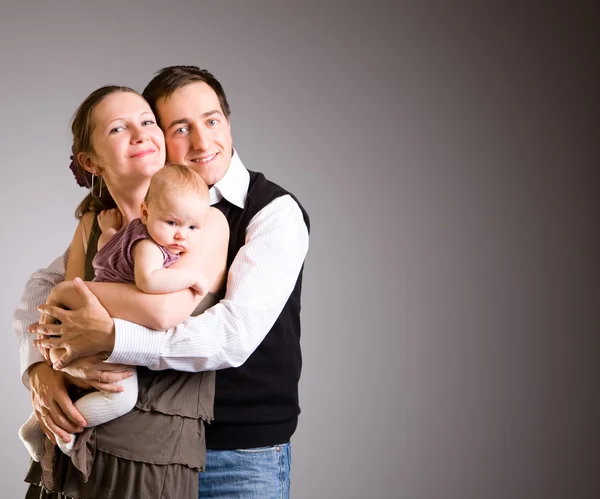 Happy young parents with baby daughter — Stock Photo, Image