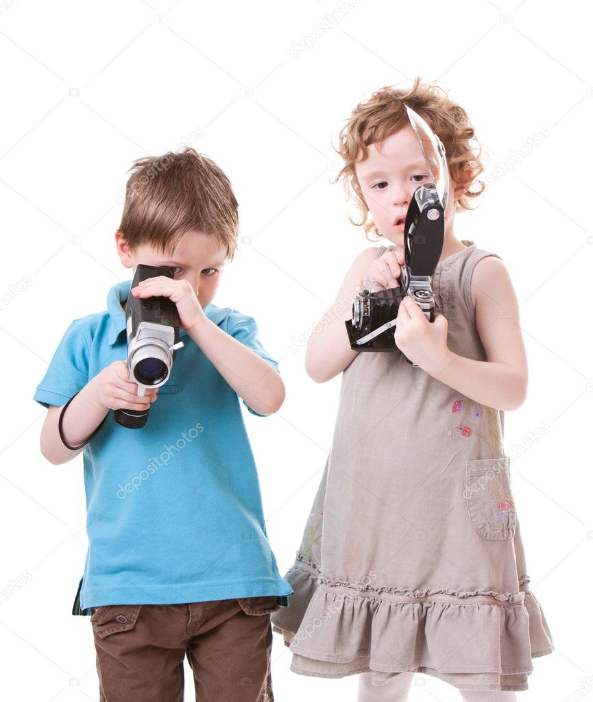 Young Photographers. Two small kids playing with antique cameras.