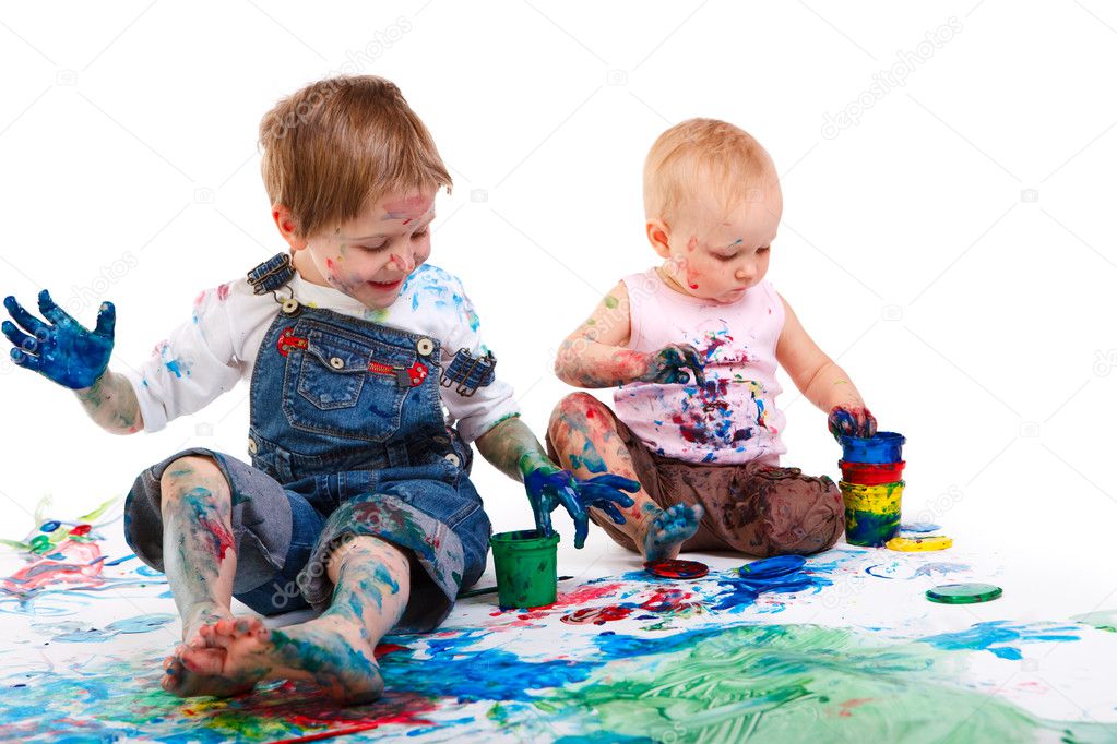 Cute 5 years old boy and toddler girl painting on white background