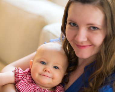 Mother and Baby portrait indoors, focus on baby. clipart