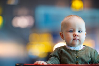 Adorable baby girl portrait at airport clipart