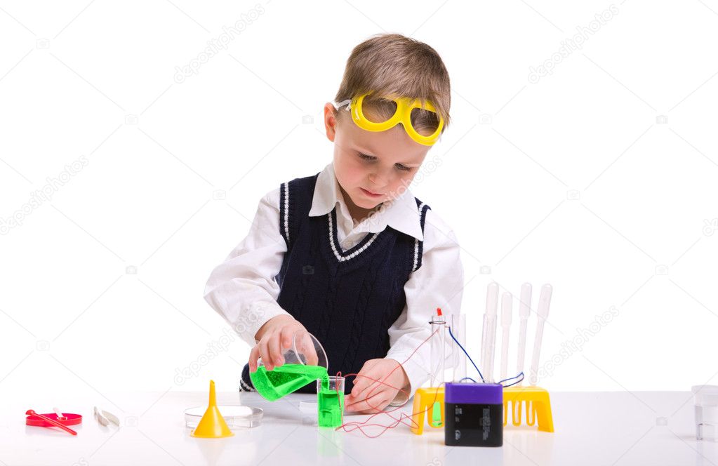 Young boy performing chemistry experiments with different liquids.