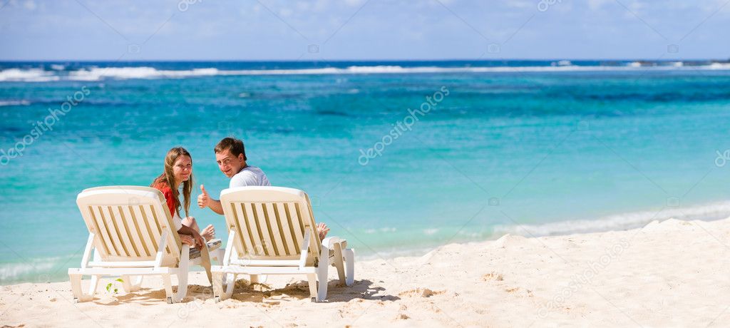 Young happy couple on white sand beach