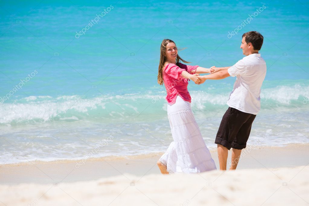 Romantic couple having fun on white sand tropical beach