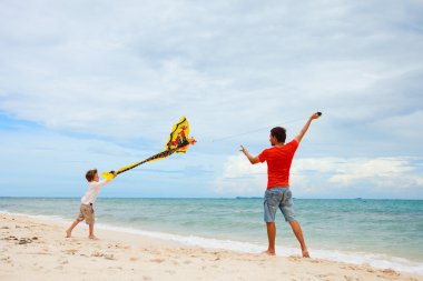 Father and son flying kite clipart