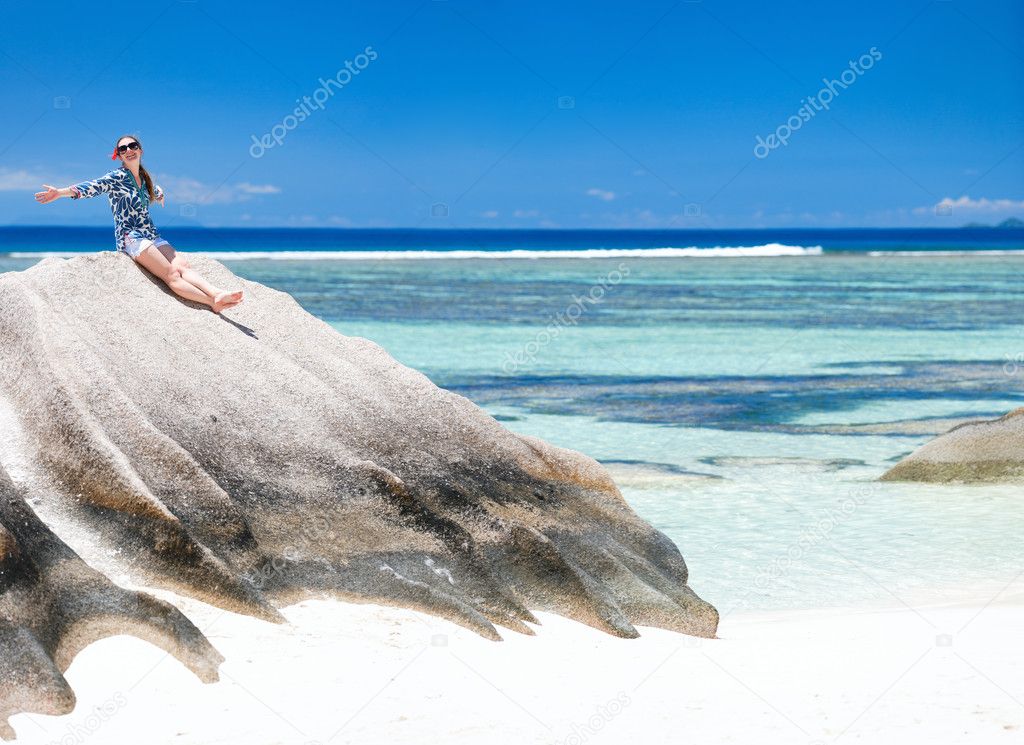 Woman sitting on top of granite rock