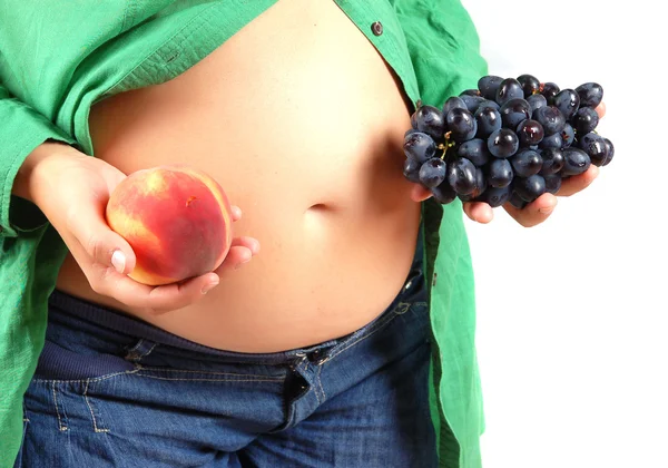 stock image Stomach of the pregnant woman decorated with fruit